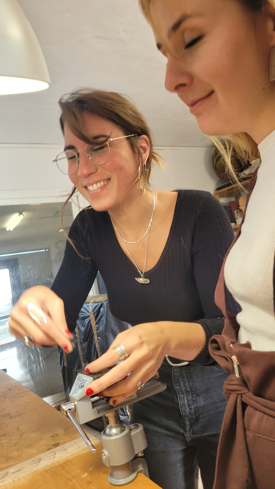 A participant smiling as she works at the bench during one of Lorenzo's workshops