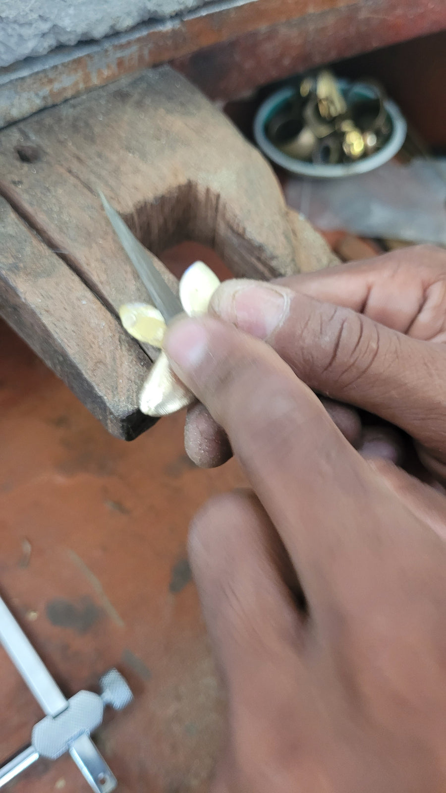 Filing a cast metal piece at the bench pin